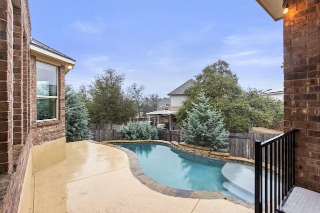 view of swimming pool with a patio area, a fenced backyard, and a fenced in pool