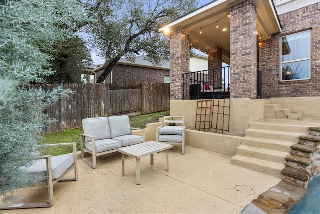 view of patio / terrace with an outdoor hangout area and fence