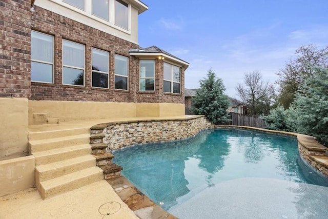 view of swimming pool featuring a fenced in pool and fence