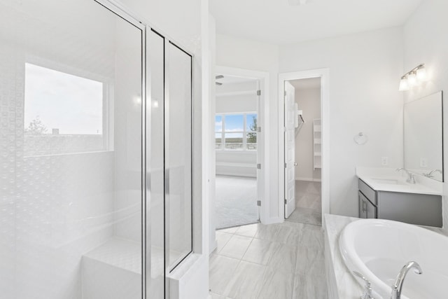 4419 College Square Dr, Round Rock, TX 78665 - full bath featuring a walk in closet, a garden tub, a stall shower, vanity, and baseboards
