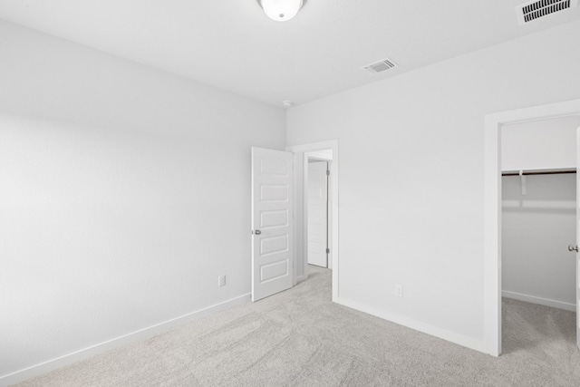4419 College Square Dr, Round Rock, TX 78665 - unfurnished bedroom featuring carpet flooring, visible vents, and a walk in closet
