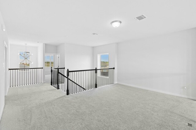 4419 College Square Dr, Round Rock, TX 78665 - empty room featuring visible vents, carpet, a notable chandelier, and a healthy amount of sunlight