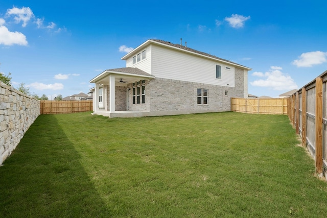 4419 College Square Dr, Round Rock, TX 78665 - back of property with a yard, brick siding, ceiling fan, and a fenced backyard