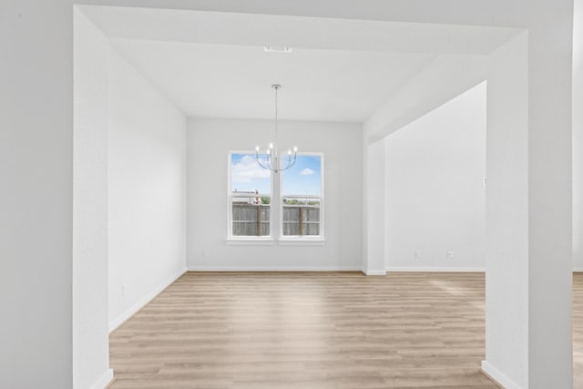 4419 College Square Dr, Round Rock, TX 78665 - unfurnished dining area with baseboards, an inviting chandelier, and light wood-style flooring