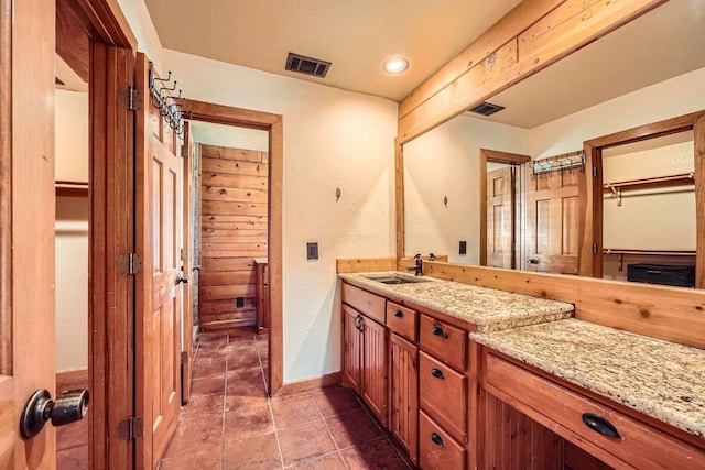 bathroom with tile patterned floors, visible vents, vanity, and baseboards