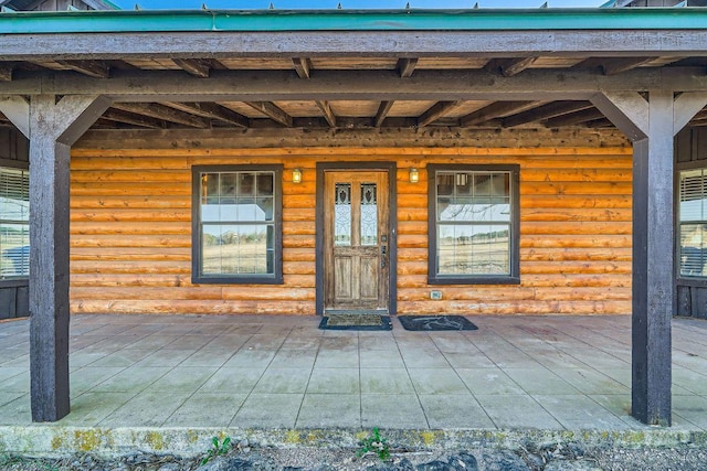 doorway to property with log veneer siding