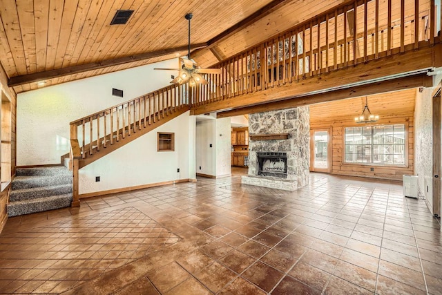 unfurnished living room featuring beamed ceiling, stairs, a fireplace, wooden ceiling, and high vaulted ceiling