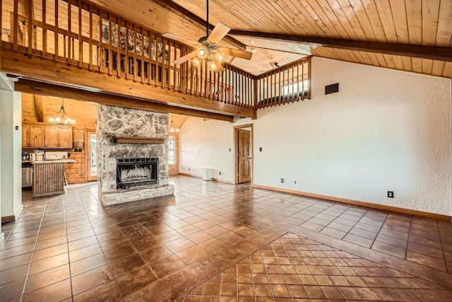 unfurnished living room with beam ceiling, wood ceiling, dark tile patterned floors, and ceiling fan with notable chandelier