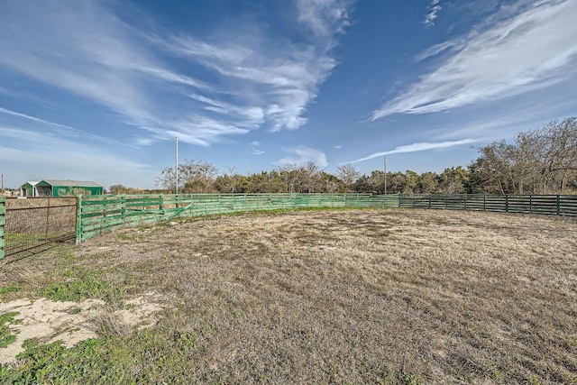 view of yard featuring a rural view and fence