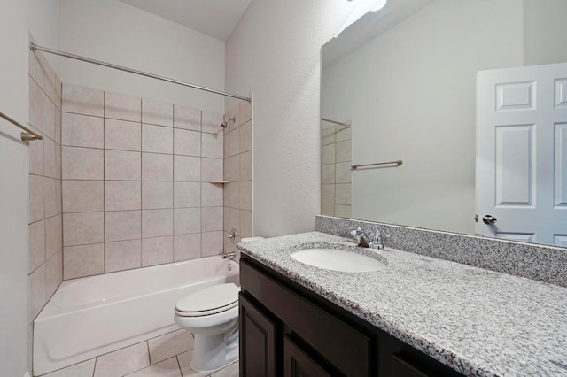 full bathroom featuring washtub / shower combination, toilet, vanity, and tile patterned flooring