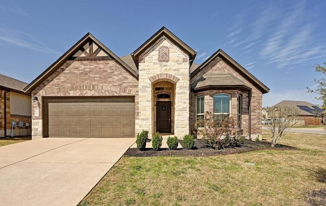 french provincial home with a garage, brick siding, concrete driveway, and a front yard