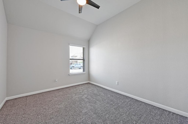 empty room with ceiling fan, baseboards, lofted ceiling, and carpet floors