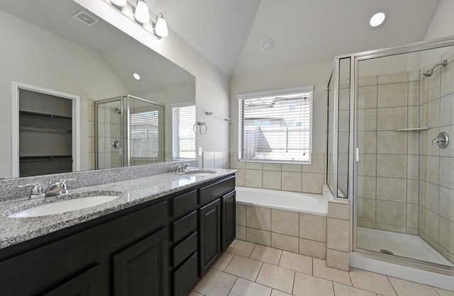 full bath with vaulted ceiling, visible vents, a stall shower, and a sink