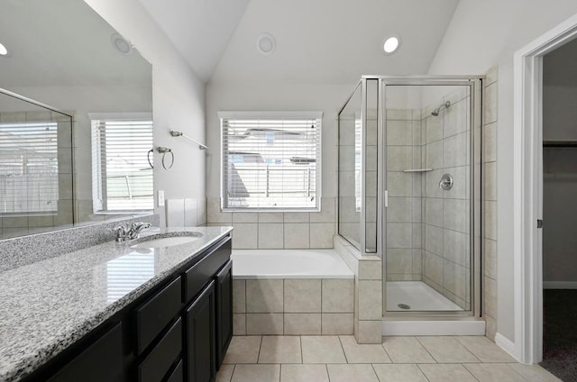 bathroom featuring tile patterned floors, a stall shower, vanity, and vaulted ceiling