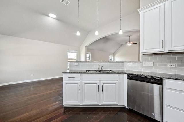 kitchen featuring visible vents, a sink, tasteful backsplash, dishwasher, and vaulted ceiling