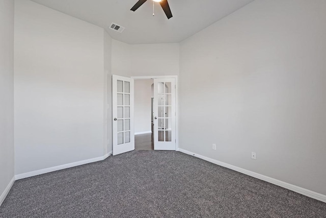 empty room with french doors, baseboards, visible vents, and dark carpet