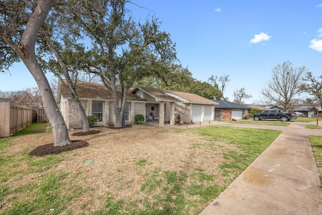 view of front of house with driveway, a front yard, a garage, and fence