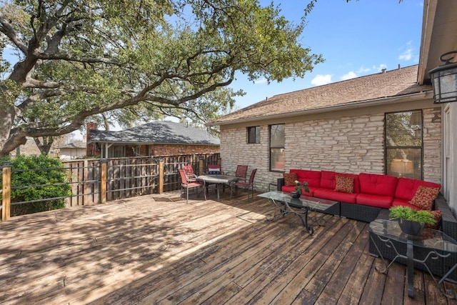 wooden deck featuring outdoor lounge area and fence