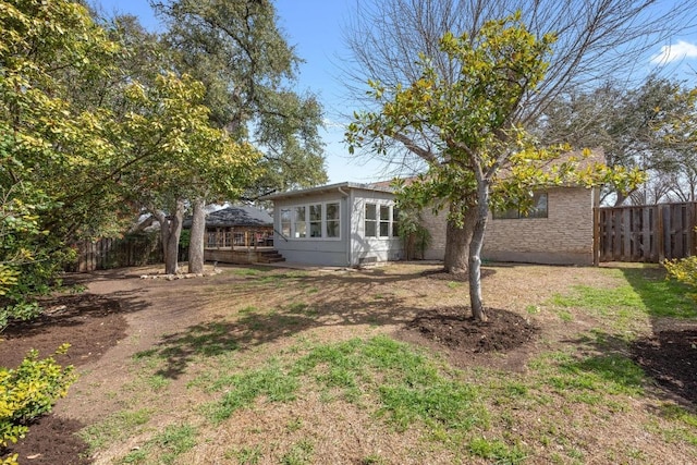 back of house featuring fence