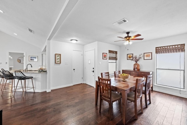 dining room with vaulted ceiling, visible vents, dark wood-style flooring, and ceiling fan