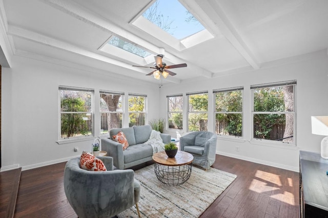 interior space featuring a skylight, plenty of natural light, and beamed ceiling