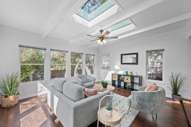 living room with a wealth of natural light, beamed ceiling, wood finished floors, and a skylight