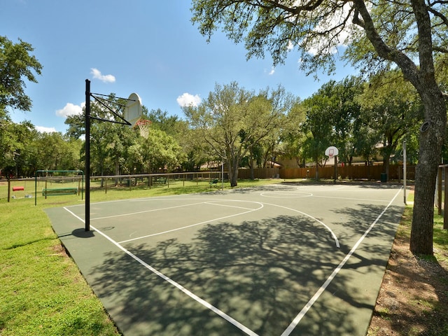 view of sport court with volleyball court, community basketball court, a yard, and fence