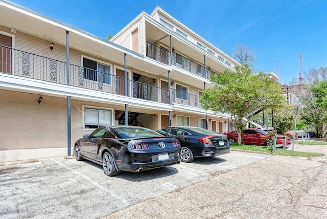 view of building exterior featuring uncovered parking