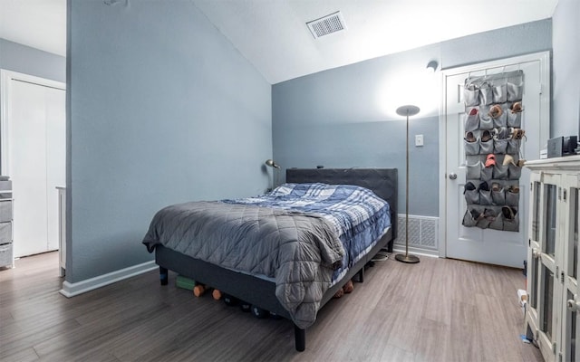 5004 Galen Ct, Austin, TX 78744 - bedroom featuring wood finished floors, vaulted ceiling, and baseboards