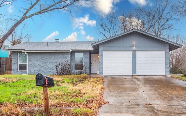 5004 Galen Ct, Austin, TX 78744 - ranch-style home with stone siding, concrete driveway, an attached garage, and a shingled roof