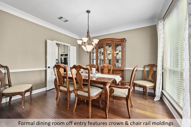 dining area featuring visible vents, ornamental molding, dark wood-style floors, baseboards, and a chandelier