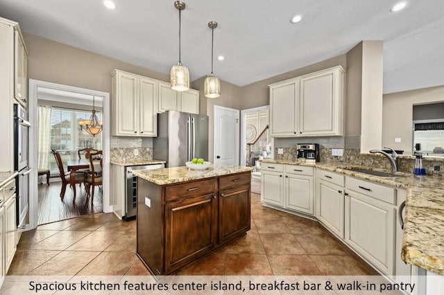 kitchen with beverage cooler, a sink, recessed lighting, appliances with stainless steel finishes, and decorative backsplash