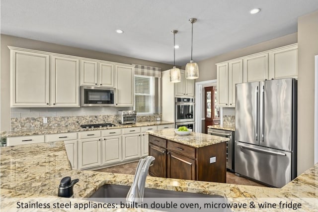 kitchen with light stone counters, decorative light fixtures, backsplash, stainless steel appliances, and a toaster