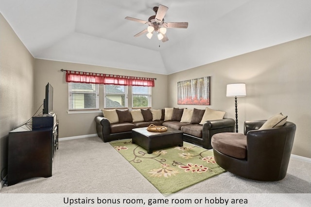 living room with ceiling fan, baseboards, carpet, and vaulted ceiling