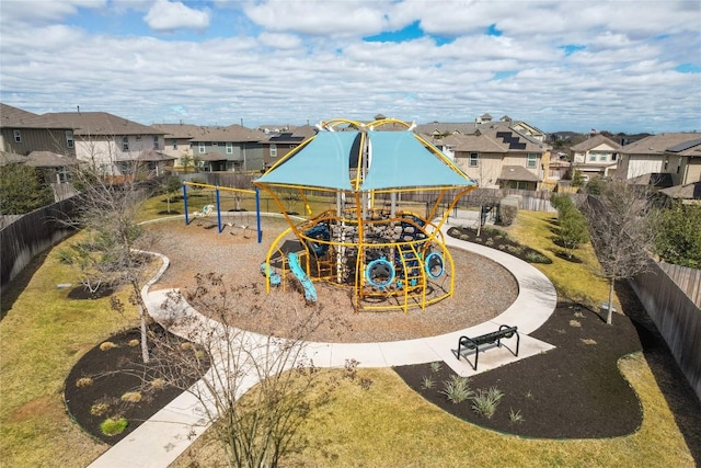 communal playground with a residential view and fence