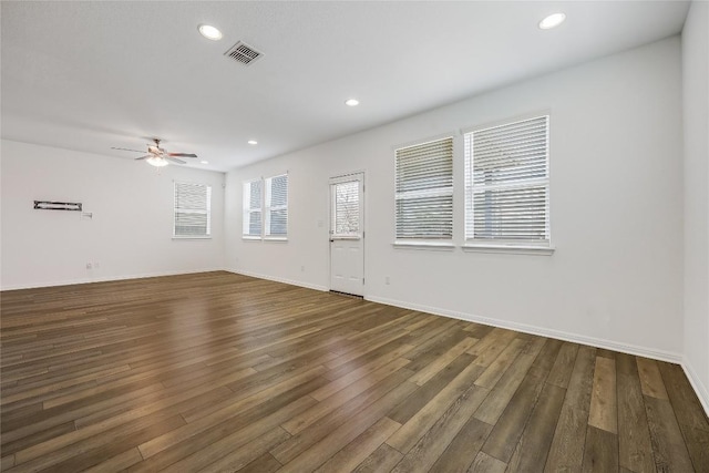 unfurnished room featuring a ceiling fan, baseboards, visible vents, dark wood finished floors, and recessed lighting