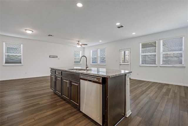 kitchen featuring a sink, a center island with sink, dark wood-style flooring, and stainless steel dishwasher