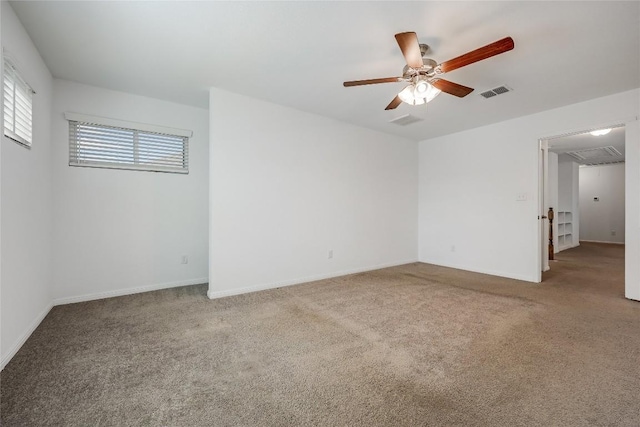 unfurnished room featuring visible vents, carpet floors, baseboards, and ceiling fan