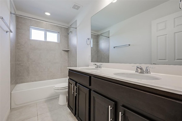 bathroom featuring shower / bathing tub combination, toilet, tile patterned floors, and a sink