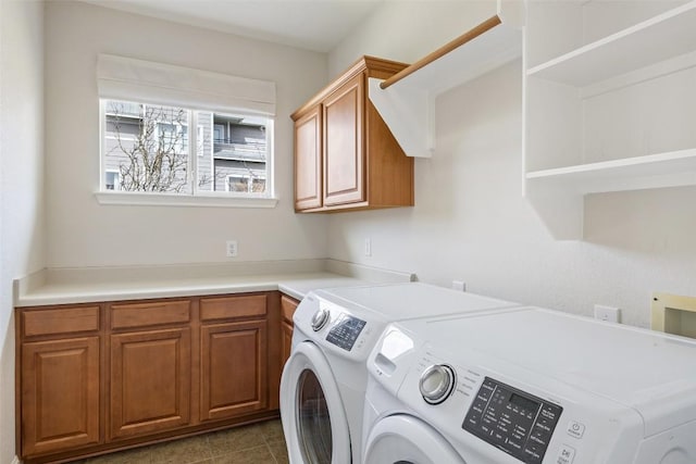 laundry room with washer and clothes dryer, tile patterned flooring, and cabinet space