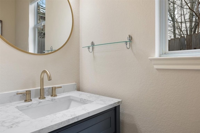 bathroom featuring vanity and a textured wall