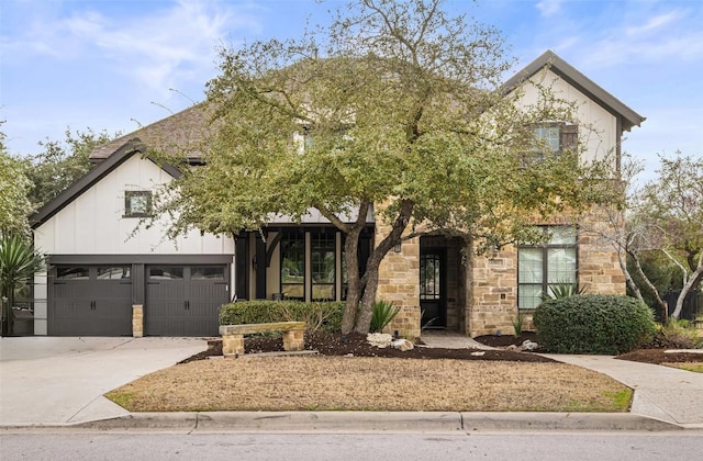 view of front of property with stone siding and driveway