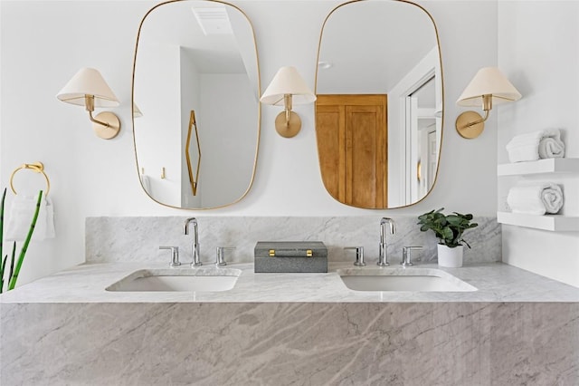 full bathroom with a sink and double vanity