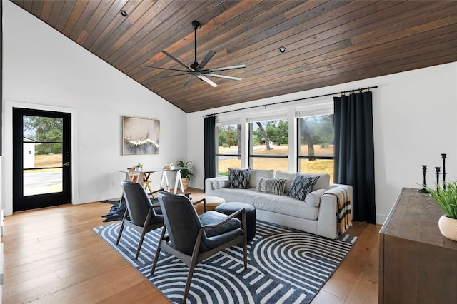 living area with ceiling fan, high vaulted ceiling, wooden ceiling, and light wood-type flooring
