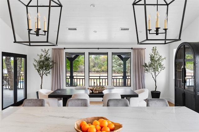 dining room with wood finished floors, baseboards, vaulted ceiling, and french doors