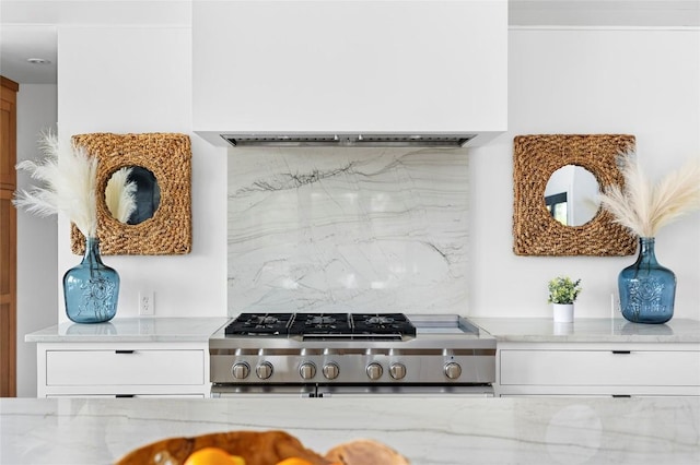 kitchen featuring range, decorative backsplash, light stone counters, and custom exhaust hood