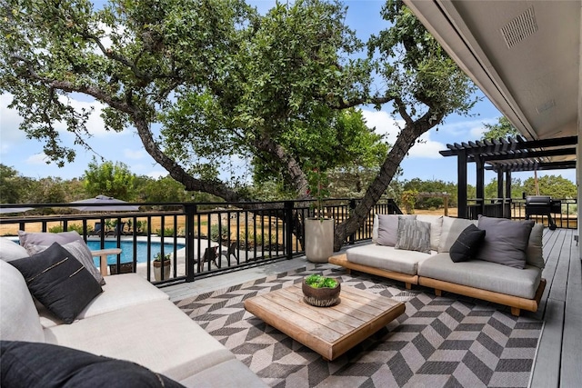 view of patio featuring a wooden deck, an outdoor living space, a pergola, and a fenced in pool