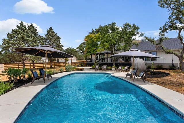 view of swimming pool with a fenced in pool, a patio, and fence