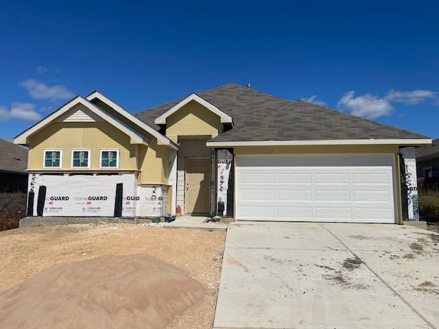 view of front of home with driveway and stucco siding