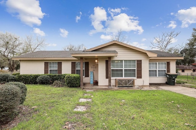 ranch-style house with brick siding and a front lawn